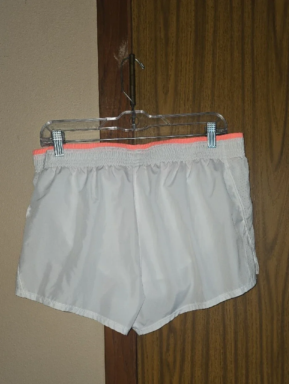 Nike Women’s White Athletic Shorts with Neon Coral Accent